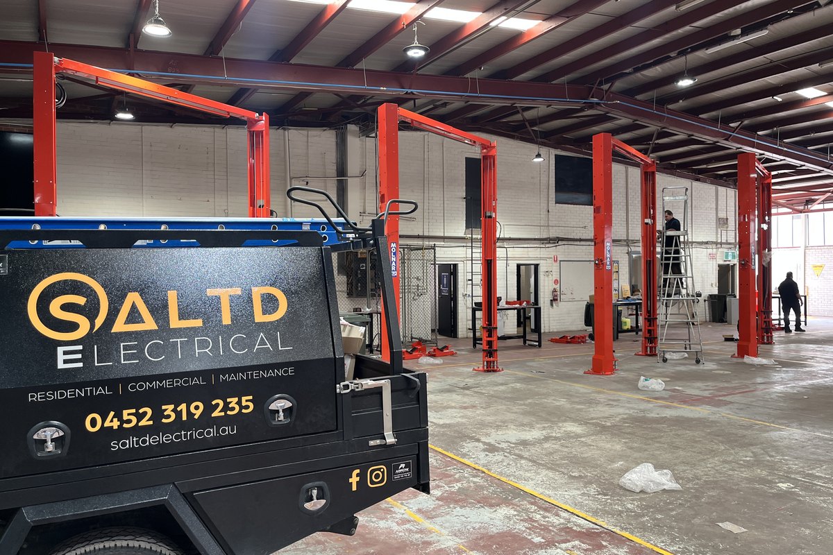 SALTD Electrical ute on site at a mechanical workshop fit-out, with power and lighting run to a row of two-post hoists