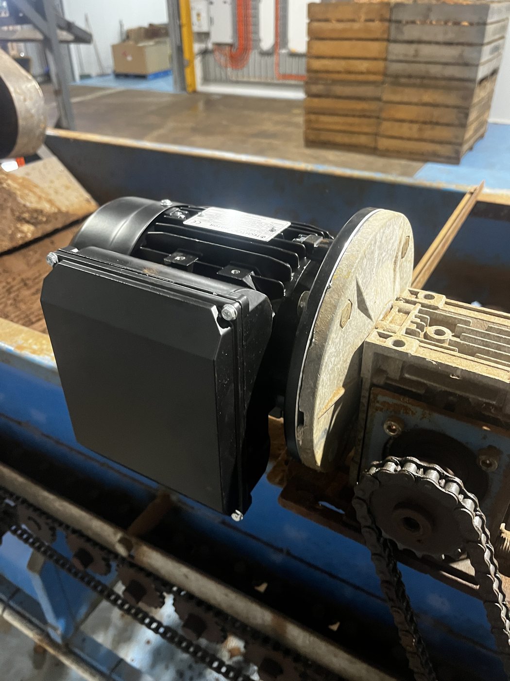 Replacement geared motor newly mounted to the worm drive and chain sprocket of a production conveyor, installed by SALTD Electrical